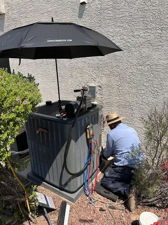HVAC technician performing outdoor AC maintenance in Fountain Hills